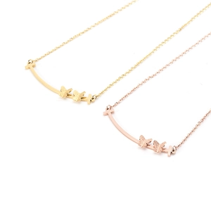 Titanium steel smiley necklace with golden butterfly accents on a sleek curved bar