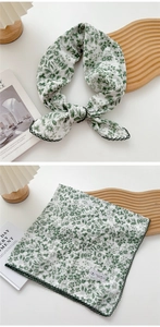 Detail of forest green floral scarf with scalloped edges and soft cotton linen texture