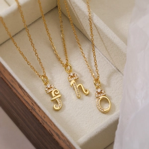 Three 18K gold plated necklaces with zircon initial pendants J, H, O in a wooden jewelry box