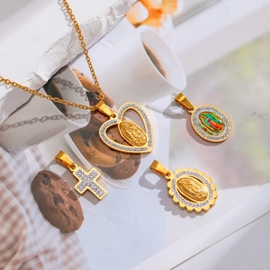 Gold religious pendant set with Virgin Mary heart, oval charms and crystal cross