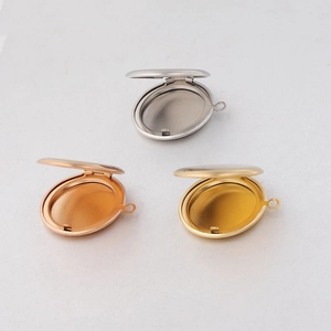 Detailed view of open oval locket pendants in silver, rose gold, and gold finish