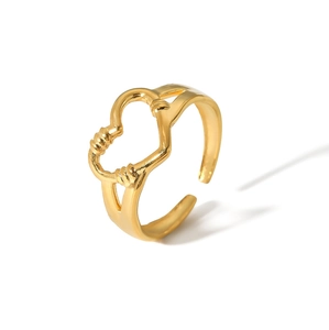 Detail shot of a hollow heart shaped gold adjustable ring with sleek curved metal design