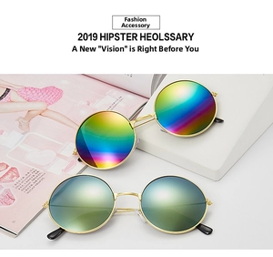 Detail of retro round metal sunglasses with colorful reflective mirror lenses in gold frames