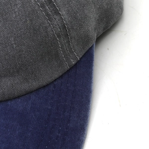 Close-up of contrast stitch on vintage washed cotton baseball cap with blue brim
