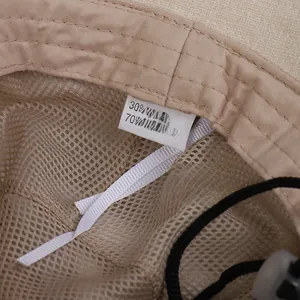Detail of linen-cotton sun hat interior with breathable mesh lining and washing label