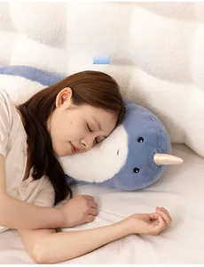 Blue narwhal plush nap pillow showing soft texture and ergonomic face support for sleeping
