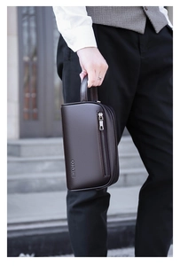 Detailed macro view of dark brown pebbled leather briefcase with silver metal zipper side