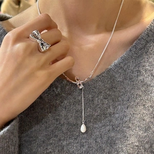 Silver bow necklace with a teardrop freshwater pearl and matching knot ring set