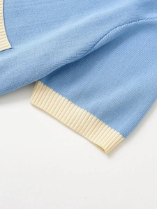 Detail of light blue and cream ribbed knit cuff on a denim style hooded jacket