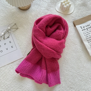 Soft cashmere-feel knit scarf in vibrant pink and rose colorblock for winter warmth