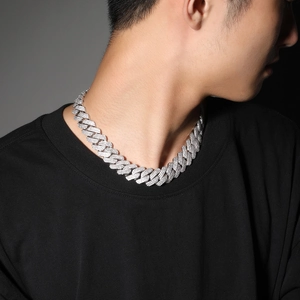 Close-up of a 20mm silver-colored iced out Cuban link chain on a male model's neck
