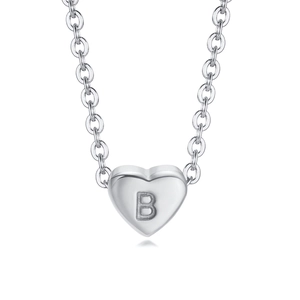 Macro shot of silver heart-shaped pendant with letter B engraving on classic chain link