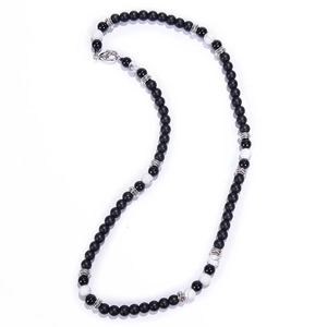 Detail view of black matte and white marble beads with silver spacers on necklace