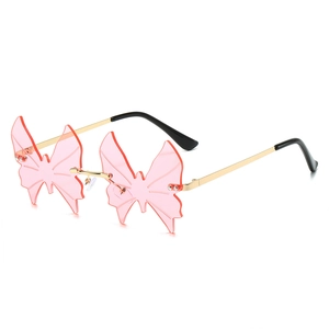 Frameless butterfly shape sunglasses for women with pink lenses and gold metal temples