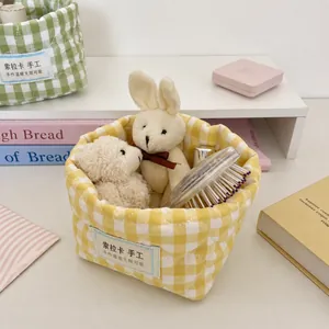 Yellow gingham padded storage basket for desktop organization shown in lifestyle setting
