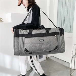 Close-up of the waterproof nylon travel bag featuring a SPORT logo and durable side straps