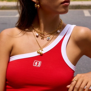 Detail shot of cherry theme jewelry set with layered necklace and cherry drop earrings