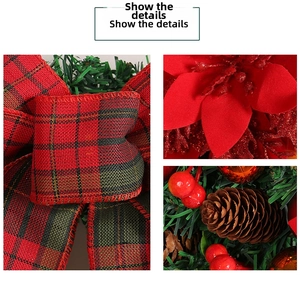 Close-up of Christmas wreath with buffalo plaid bow, pine cones, and red berries