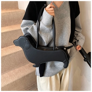 Detail of creative dachshund shaped black tote bag with zipper and dual handle design