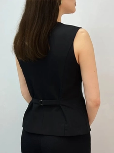 Rear view of black V-neck sleeveless vest with adjustable back buckle strap details