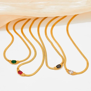 Gold plated snake chain necklace set with oval emerald, ruby, and obsidian stone pendants