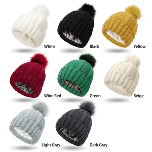 Knit beanie with faux fur pom and satin lining for hair protection in multiple colors