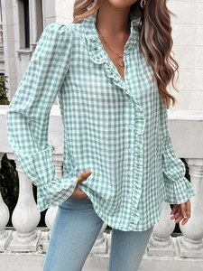 Detail of mint green and white plaid shirt with ruffle collar and button-up design