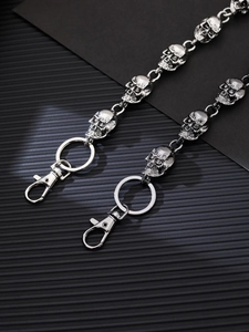 Detailed view of silver skull head biker chain with heavy duty metal clasps and rings