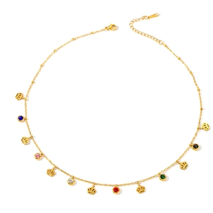 Detail of gold titanium steel necklace featuring crown charms and colorful zircon stones