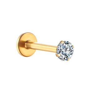 Macro detail of golden G23 titanium labret stud featuring a four-prong set round zircon