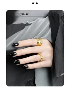 Wearing display of matte wide wave layered rings and geometric gold bands on fingers