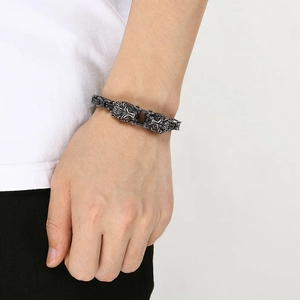 Close-up of vintage lion head steel bracelet with blackened imperial chain on wrist