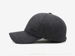 Close-up of winter wool baseball cap with SPORT metal logo and ear protection