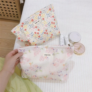 Detailed view of floral makeup bags with zip closure and minimalist simple wish labels