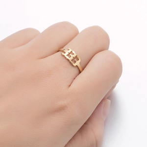 Detail of gold-plated stainless steel ring featuring 333 cutout number on finger