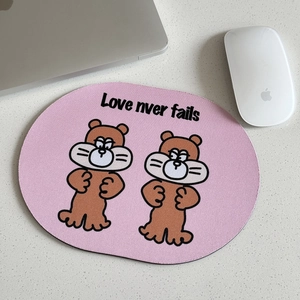 Pink oval mouse pad with cartoon otters and Love Never Fails text for laptop desk