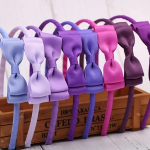 7-piece set of colorful grosgrain ribbon bow headbands in various purple and blue shades