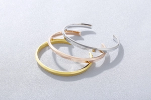 Polished gold, silver, and rose gold cuff bracelets with engraved My Life One Love text