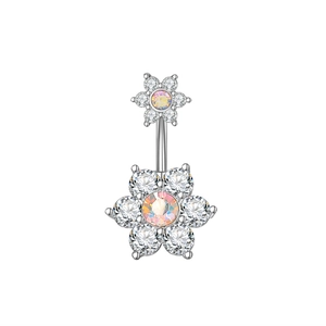 Detail of silver navel piercing featuring sparkling zircon floral design and iridescent stones