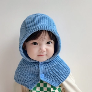 Blue knit children's hooded scarf and earflap hat combo with soft texture and buttons