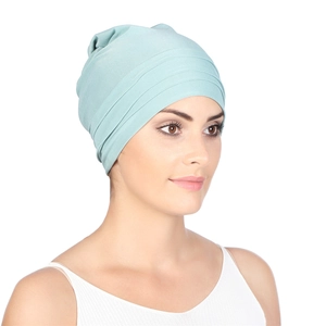 Detailed view of the pleated texture and soft fabric on this light teal fashion turban cap