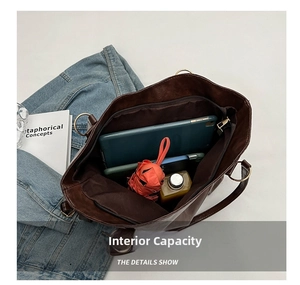 Top view of spacious interior with tablet, umbrella, and phone inside brown tote bag