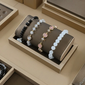 Jewelry display stand featuring beaded bracelets with crystal and gold accents