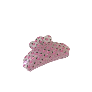 Pink acrylic hair claw clip with strawberry pattern and hollow out design on white background