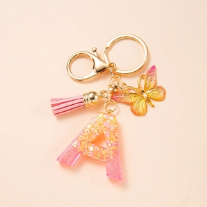 Pink and orange gradient resin letter A keychain with butterfly charm and suede tassel