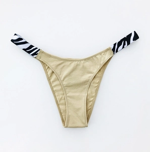 Detail of cotton bikini bottom with gold fabric and zebra print waistband stitching