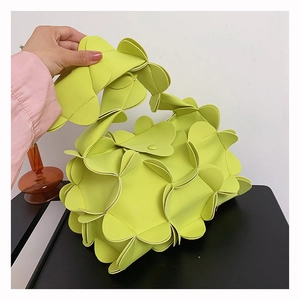 Detailed view of neon green petal-shaped PU leather bag with 3D layered design