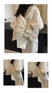 Detailed view of beige canvas tote bag with large bowknot design on shoulder model