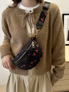 Stylish black crossbody chest bag with red cherry prints and golden hardware accessories