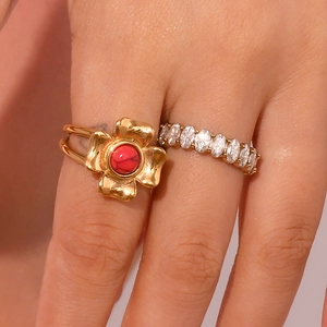 Close-up of 18K gold plated flower ring with red gemstone and open band design